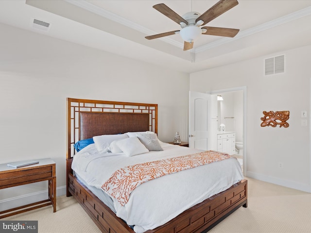 bedroom with a raised ceiling, visible vents, light carpet, and baseboards