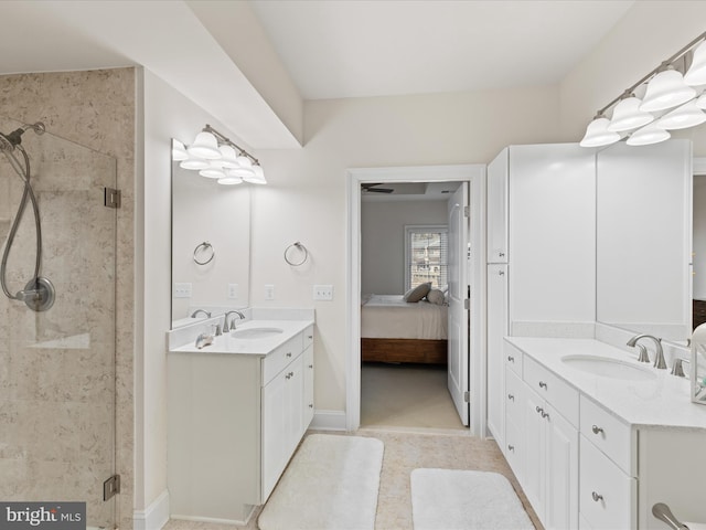 ensuite bathroom with ensuite bath, a shower stall, two vanities, and a sink