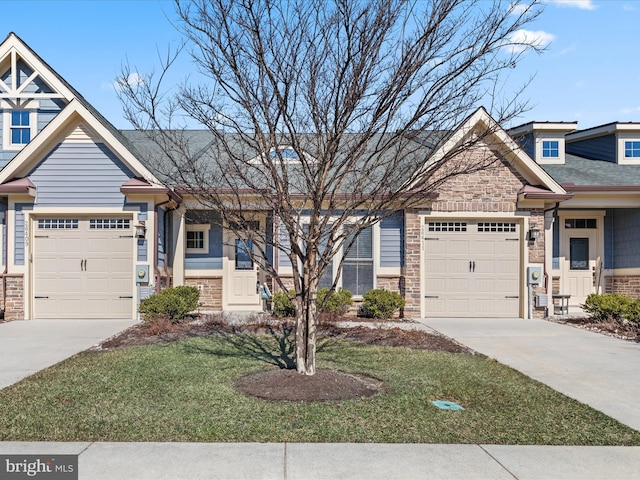 craftsman inspired home with driveway, stone siding, a garage, and a front yard