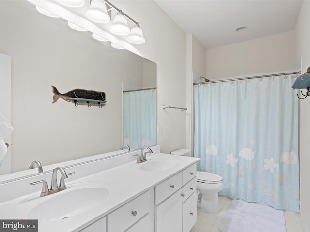 full bathroom featuring toilet, tile patterned flooring, double vanity, and a sink