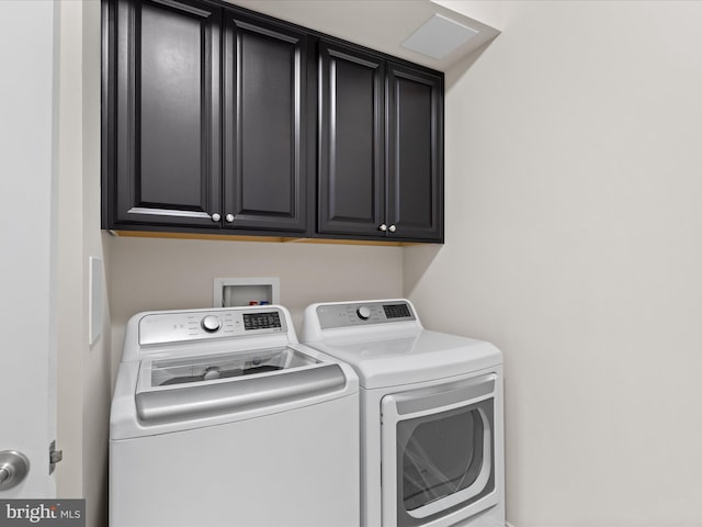 laundry room featuring washing machine and dryer and cabinet space