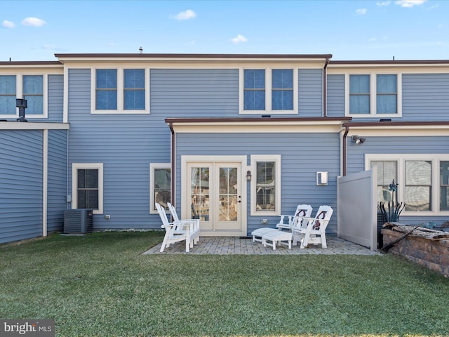 back of property featuring a lawn, a patio area, and cooling unit