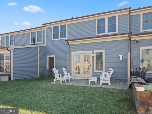 rear view of property featuring a patio and a yard