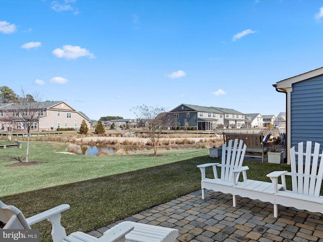 view of patio / terrace featuring a water view and a residential view