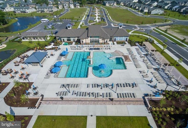 bird's eye view featuring a water view and a residential view