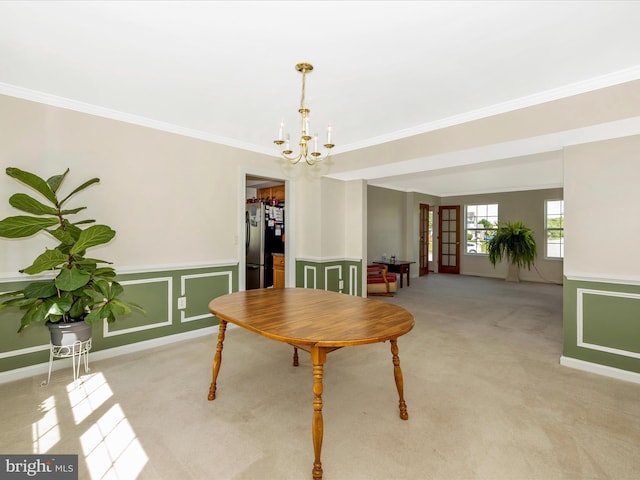 330 Mountaineers Way, Emmitsburg, MD 21727 - dining area with light colored carpet, a chandelier, crown molding, and a wainscoted wall