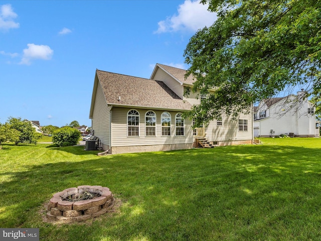 330 Mountaineers Way, Emmitsburg, MD 21727 - back of property featuring a lawn, central AC, a fire pit, and a shingled roof