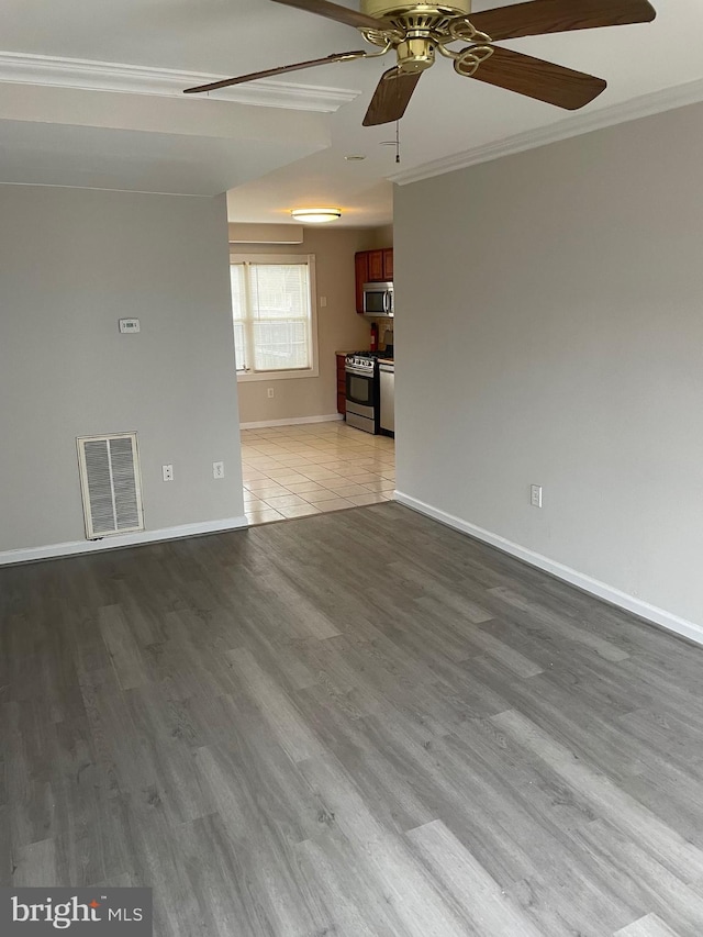 unfurnished living room with light wood-type flooring, ceiling fan, and ornamental molding