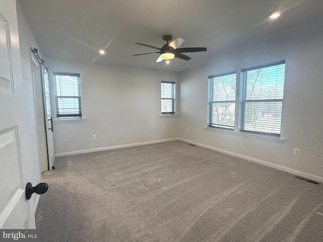 empty room with carpet floors and ceiling fan