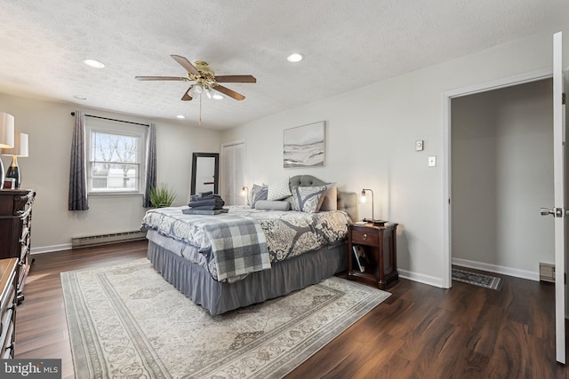 bedroom featuring dark hardwood / wood-style flooring, a textured ceiling, and a baseboard radiator