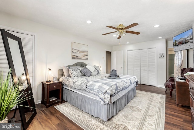 bedroom with ceiling fan, dark hardwood / wood-style flooring, and a textured ceiling