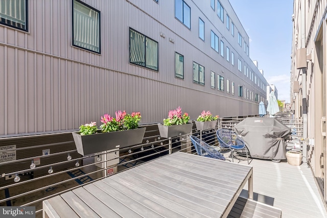 wooden terrace featuring area for grilling