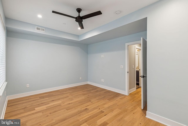 empty room with ceiling fan and light wood-type flooring