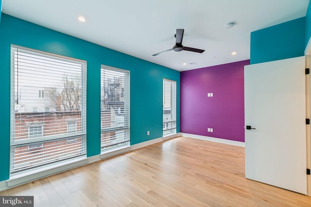 spare room featuring ceiling fan and light hardwood / wood-style flooring