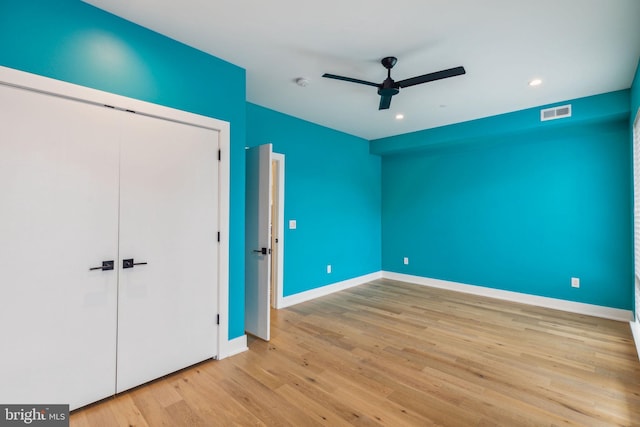 unfurnished bedroom featuring a closet, ceiling fan, and light wood-type flooring