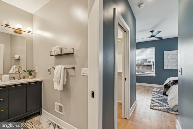 bathroom with vanity, hardwood / wood-style floors, and ceiling fan