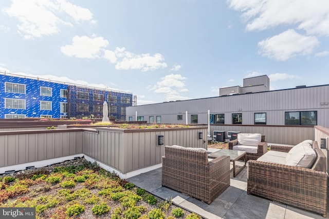 view of patio with an outdoor living space and central air condition unit