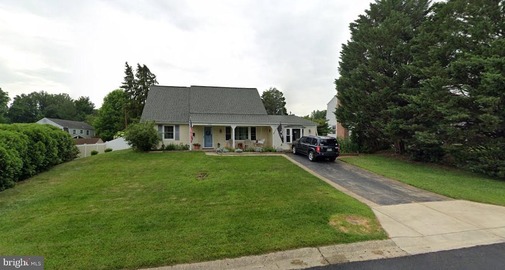 view of front of property with a front yard and a porch