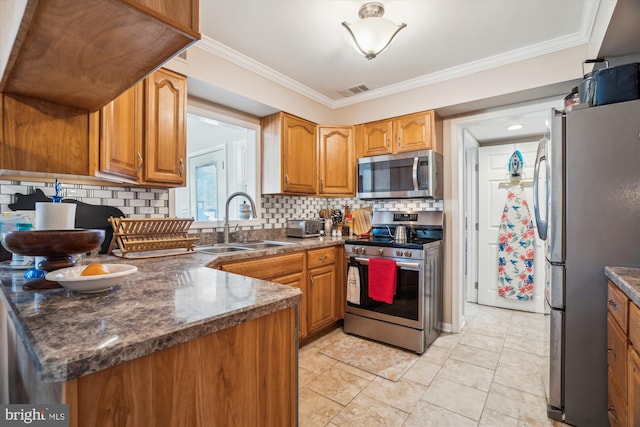 kitchen with appliances with stainless steel finishes, brown cabinetry, crown molding, and a sink