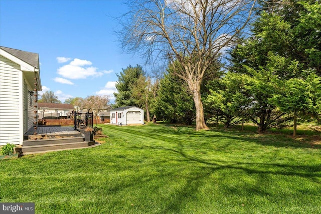 view of yard featuring a wooden deck and an outdoor structure
