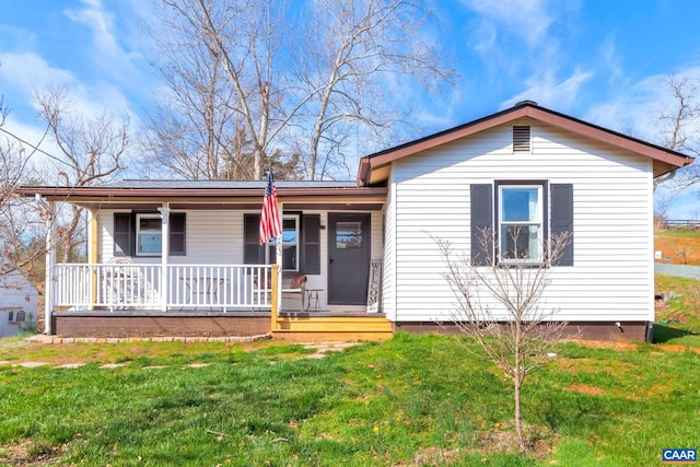 view of front of home with a front yard and covered porch