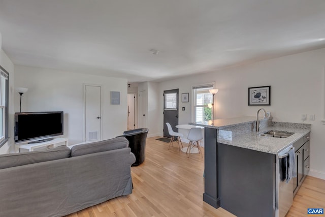 living room with sink and light hardwood / wood-style floors