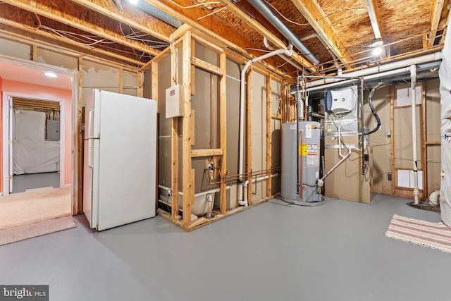 unfinished basement featuring gas water heater, freestanding refrigerator, and electric panel