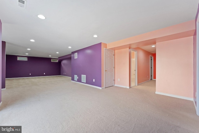 finished basement featuring recessed lighting, light carpet, visible vents, and baseboards