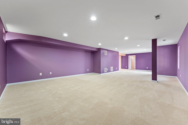 finished below grade area featuring recessed lighting, visible vents, baseboards, and light colored carpet