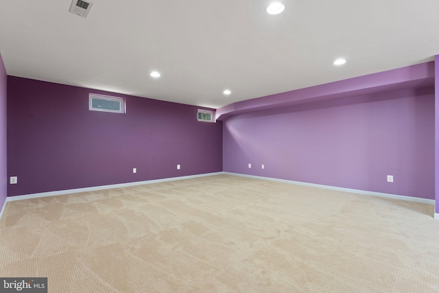 finished basement featuring baseboards, recessed lighting, visible vents, and light colored carpet