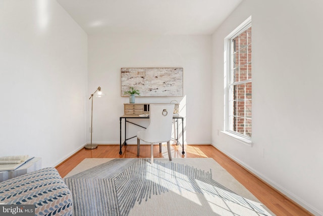 interior space with wood finished floors and baseboards