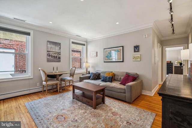 living area featuring baseboards, visible vents, crown molding, light wood-style floors, and track lighting