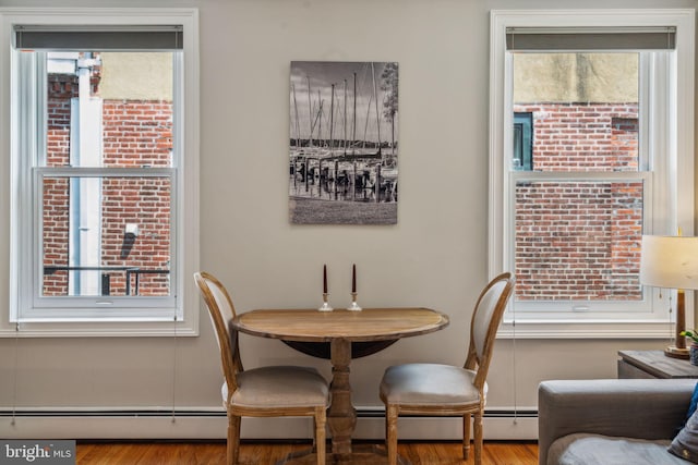 dining area featuring light wood-type flooring and baseboard heating