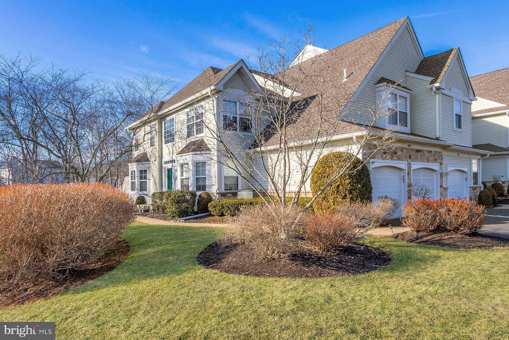 view of front of home featuring a garage and a front lawn