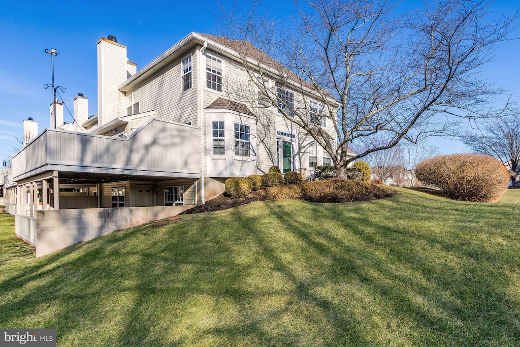 view of side of property with a lawn