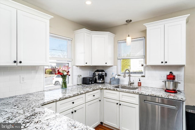 kitchen with sink, white cabinetry, and dishwasher