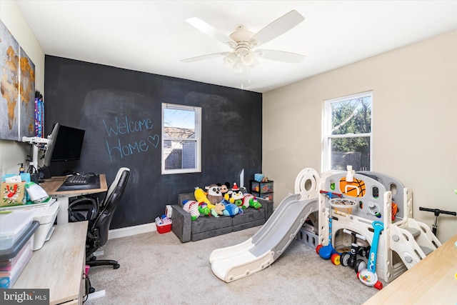 carpeted office with a wealth of natural light and ceiling fan