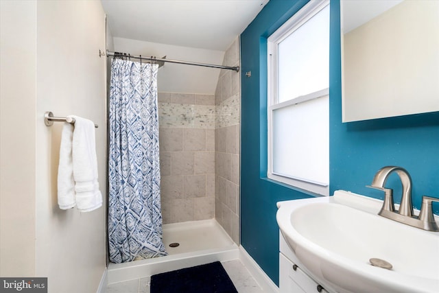 bathroom with sink and a shower with shower curtain