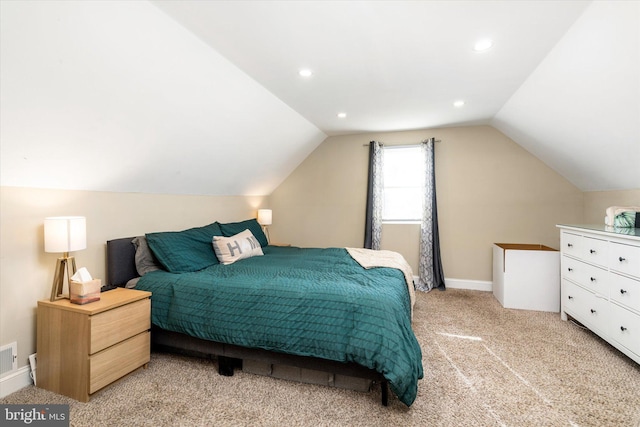 bedroom with vaulted ceiling and light colored carpet