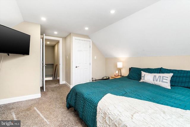 carpeted bedroom with vaulted ceiling