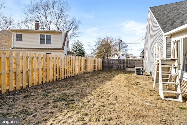 view of yard featuring central air condition unit