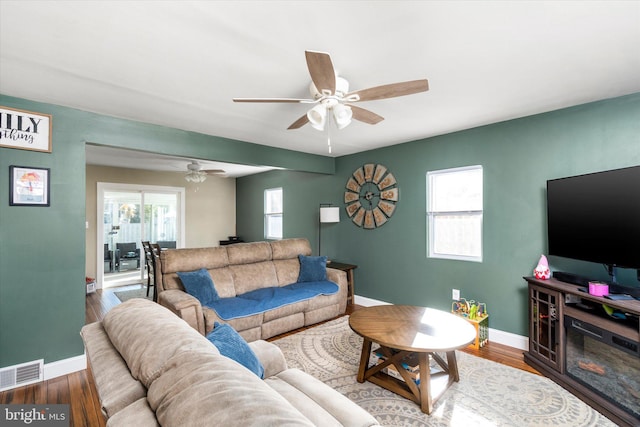 living room featuring ceiling fan, a wealth of natural light, and hardwood / wood-style floors