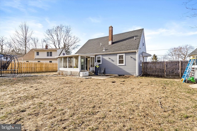 back of property featuring a patio area, a yard, a sunroom, and a playground