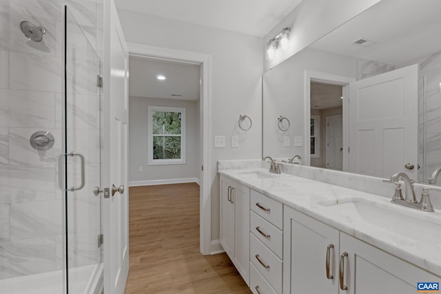 bathroom featuring vanity, a shower with door, and hardwood / wood-style floors