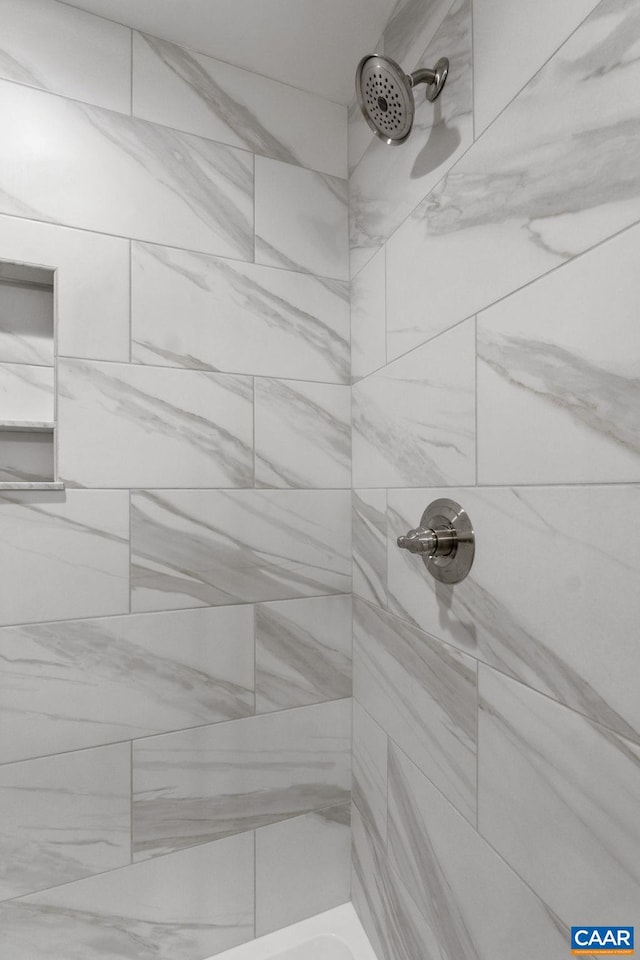 bathroom with tiled shower