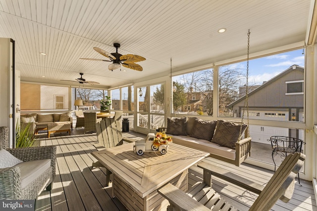 sunroom / solarium featuring a wealth of natural light and a ceiling fan