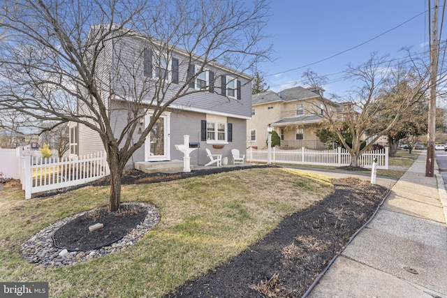 view of front facade with a front yard and a fenced front yard