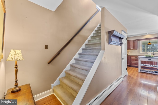 stairway with hardwood / wood-style flooring and baseboards