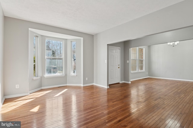 interior space with an inviting chandelier and hardwood / wood-style flooring