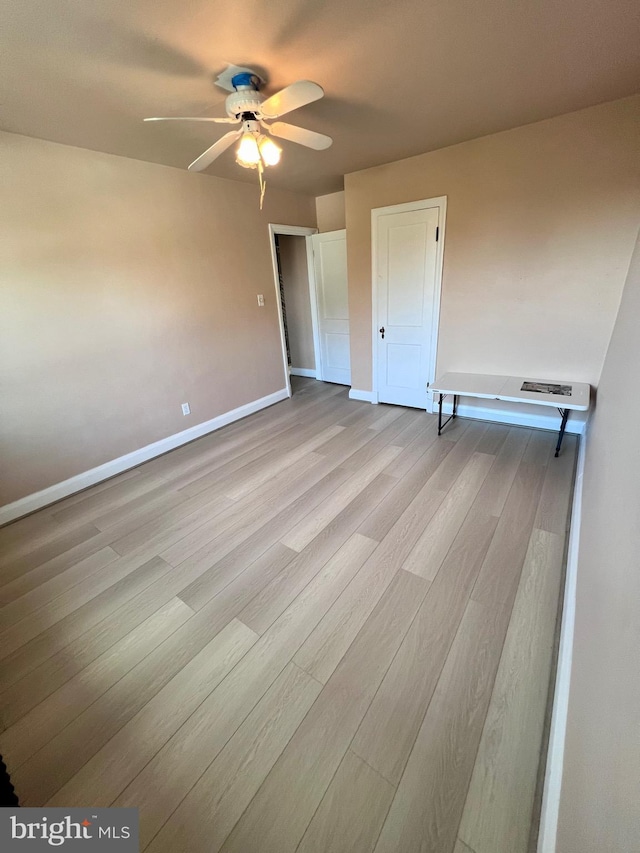 unfurnished bedroom featuring ceiling fan and light wood-type flooring